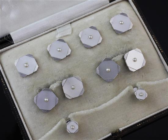 A 1920s 9ct white gold, mother of pearl and split pearl set eight piece dress stud set,